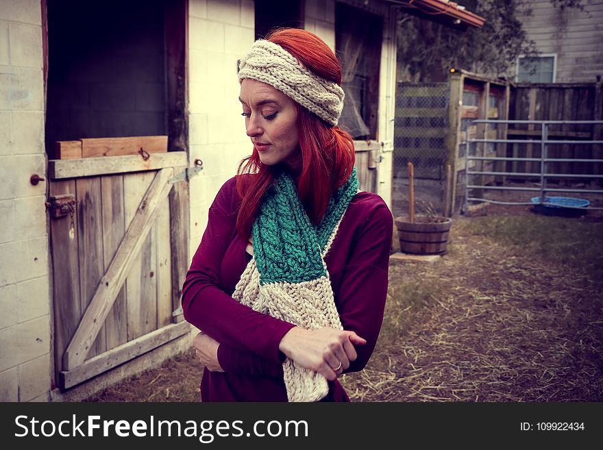 Woman in Purple Sweatshirt Wearing Knitted Beanie and Scarf