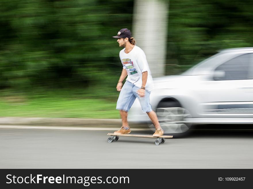 Man Playing Longboard on Road