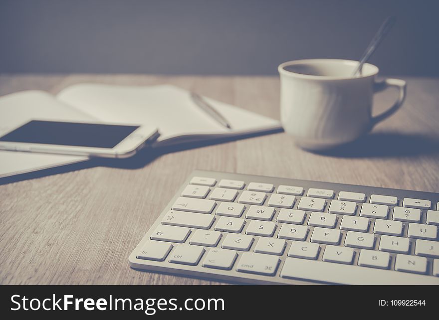 Magic Keyboard Beside Coffee Mug On Desk