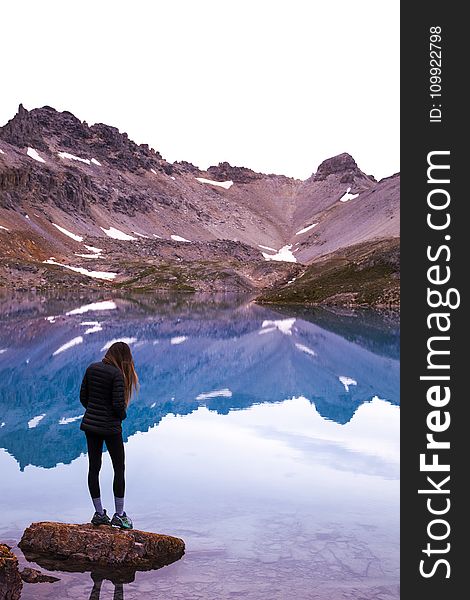 Woman Standing On Rock By The Lake And Mountain