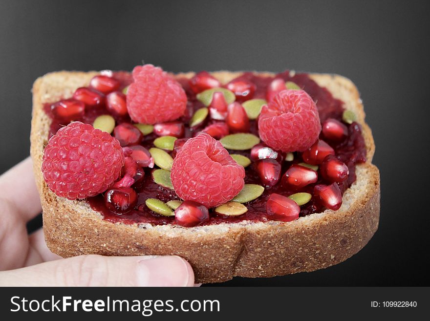 Person Holding Brown Bread With Strawberries