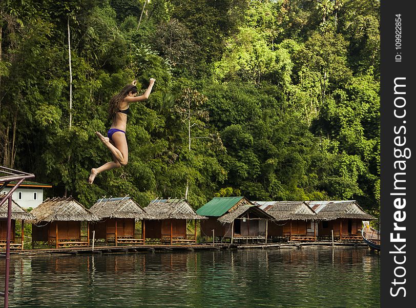 Photography of a Woman Jumping Into The Water