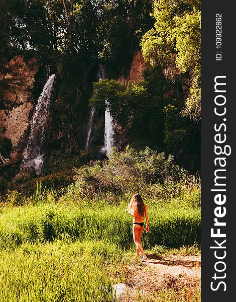 Woman In Black Bikini Bottom Walking Towards Waterfall