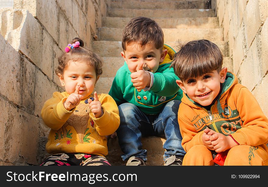 Children Sitting On The Stairs Doing Pose