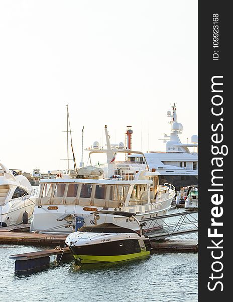 White Yacht Parked On Wooden Dock