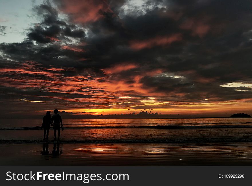 Two Person Standing on Beach Silhouette Photo