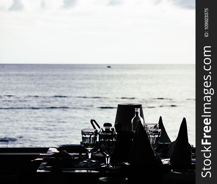 Grayscale Photography Of Four Sherbet Glasses On Table