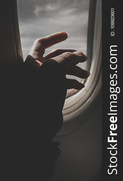 Hand By Airplane Window