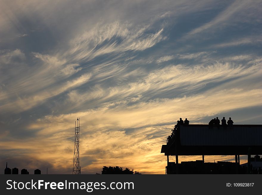 Silhouette of Building With People Standing during Golden Hour