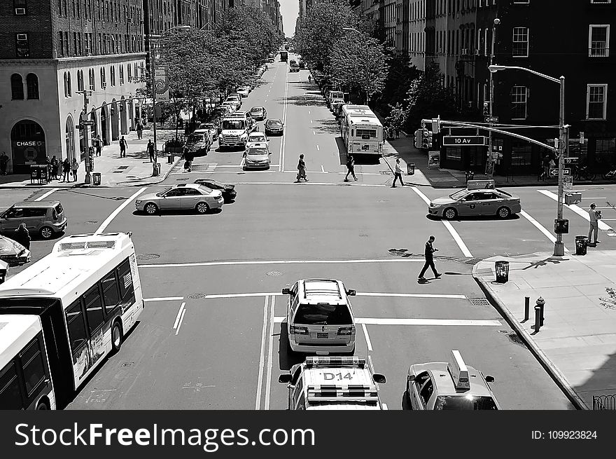 Greyscale Photo of Car and People on Streets