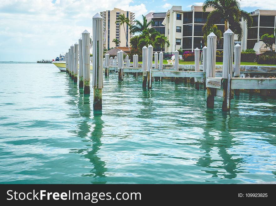 Photo of White Wooden Dock on Body of Water