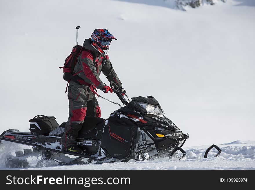 Person Riding on Snowmobile