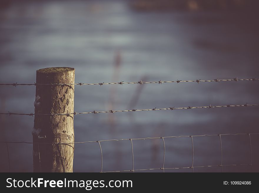 Selective Focus Photography Of Fence
