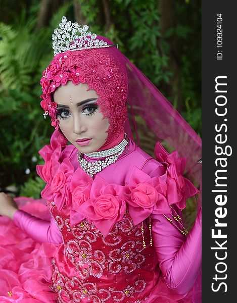 Woman Wears Pink Long-sleeved Dress With Crown