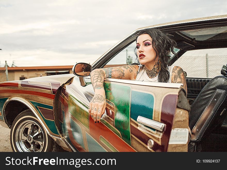 Woman With White Tank Top Inside Classic Multicolored Car