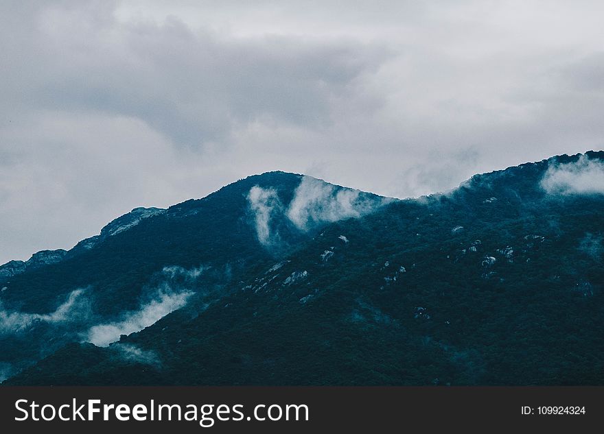 Photography of Mountain Under Cloudy Sky