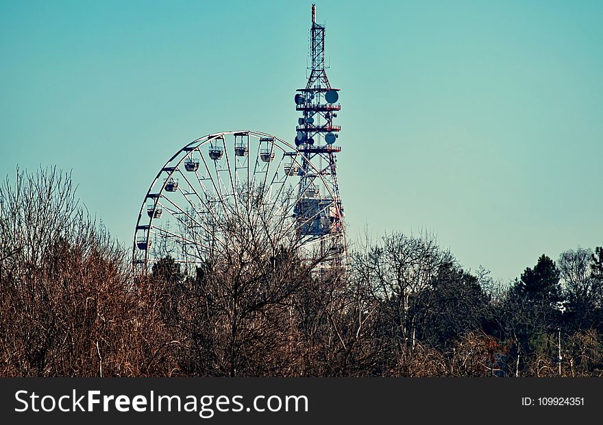 Photo of a Ferris Wheel Beside Tower