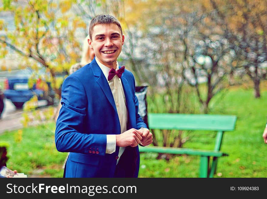 Man Wearing Blue Suit in Park