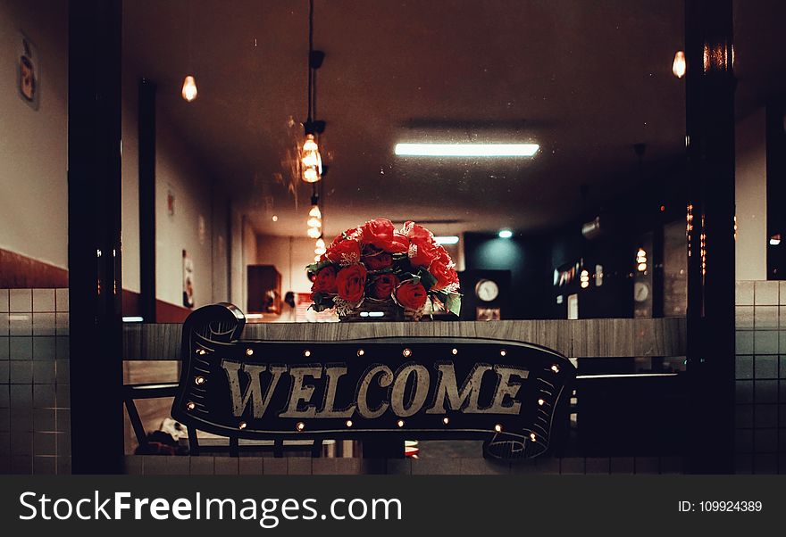 Black Welcome Signage Under Pendant Lamp Photography