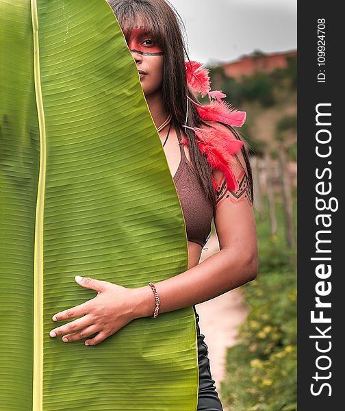 Woman In Brown Brassiere In Front Of Banana Leaf