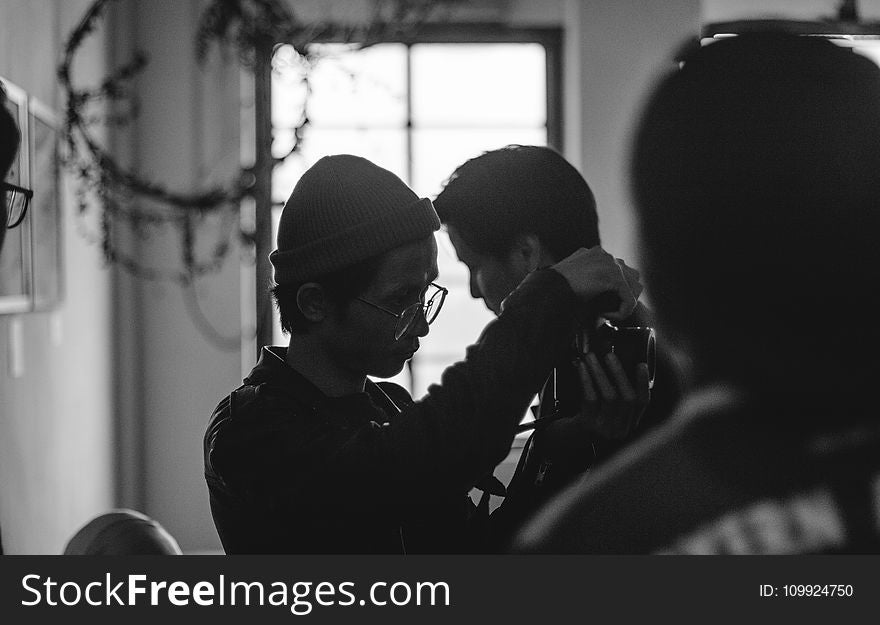 Grayscale Photo of Man Holding Man&#x27;s Neck