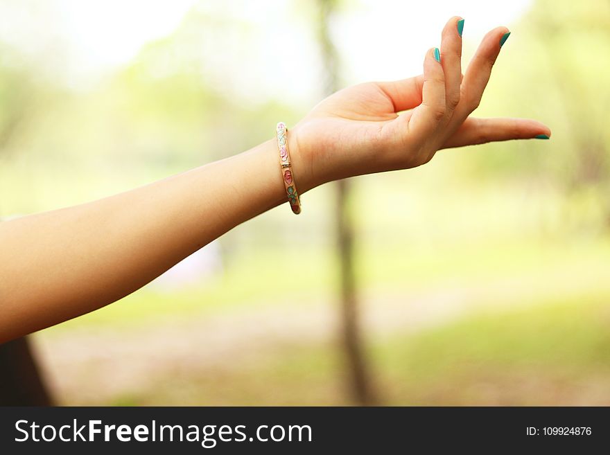 Close-Up Photography of Girl&#x27;s Left Hand Wearing Bracelet