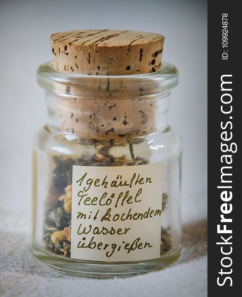 Paper Inside Clear Glass Jar With Brown Cork