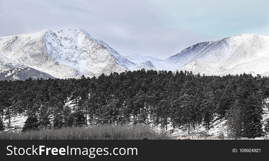 Snow Covered Mountains Under Cloudy Sky