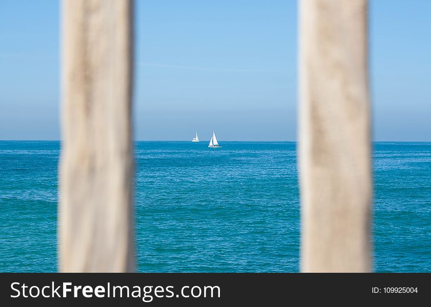 White Sailing Boat On Body Of Water