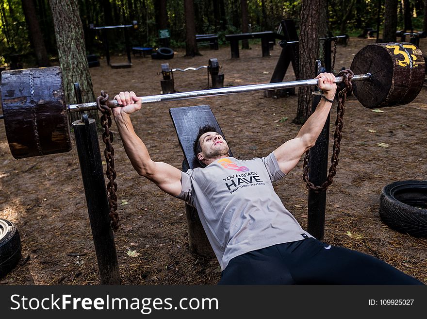 Man In Grey Shirt And Black Bottom Lifting Barbell