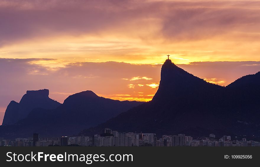 Silhouette Of Mountains With Cross