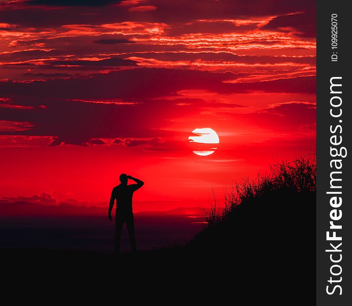 Silhouette of Man during Red Sun
