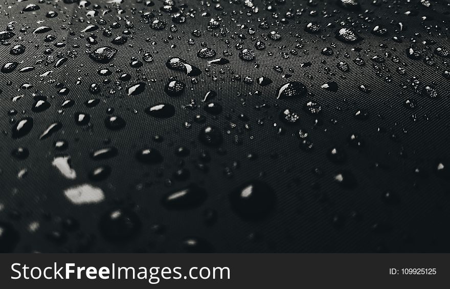 Macro Photography Of Rain Drops On Black Surface