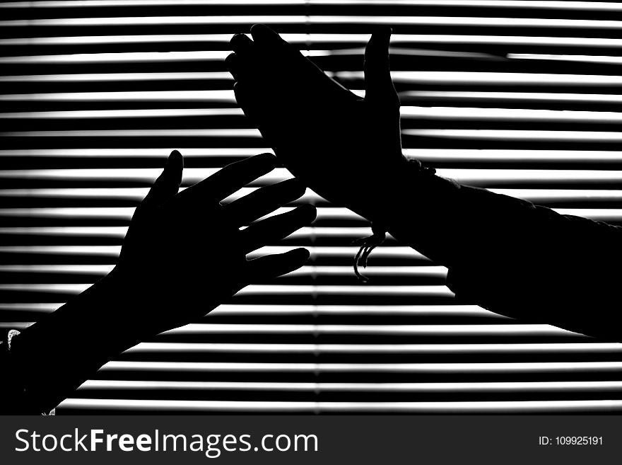 Silhouette Of Hands With Venetian Blinds Background