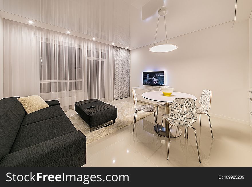 Black Fabric Sofa Near Round White Table