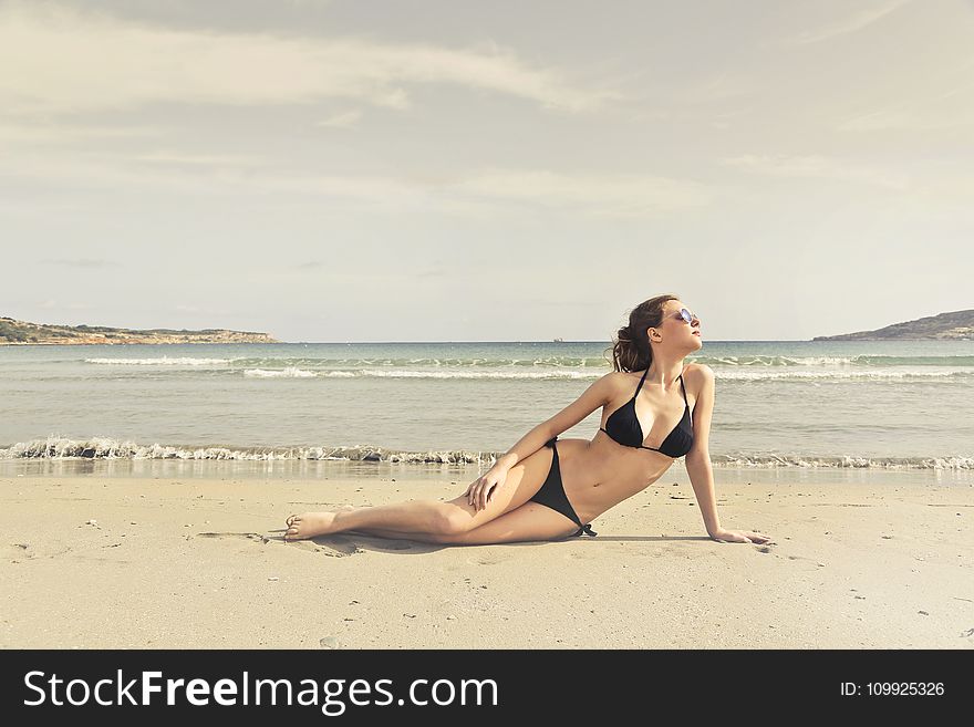 Woman in Black Bikini on Seashore