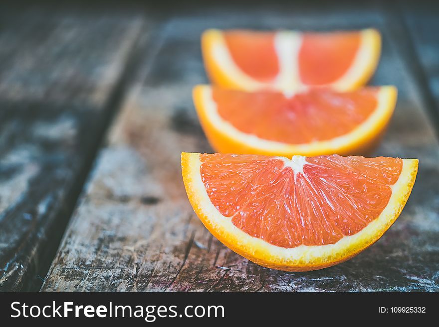 Three Sliced Orange Fruits