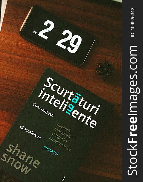Black Android Smartphone Beside Scurtaturi Inteligente Book