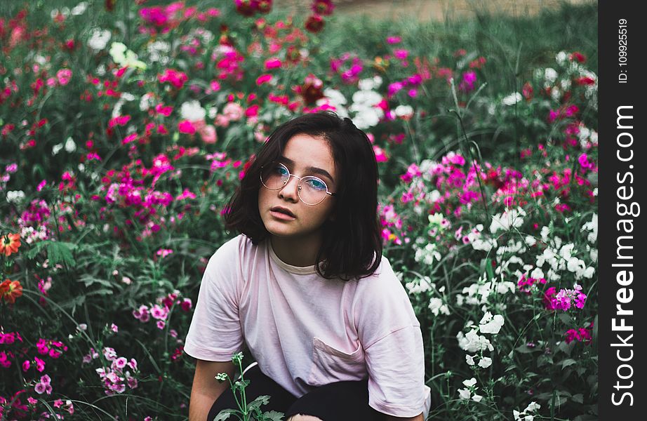 Girl in White T-shirt Surrounded by Flowers