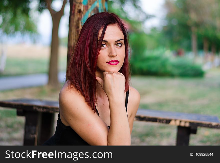 Woman In Black Tank Top Sitting On Bench