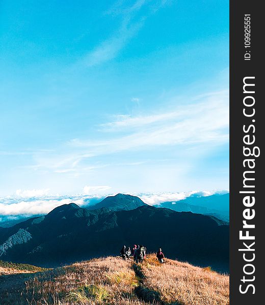 People Walking On Top Of Mountain