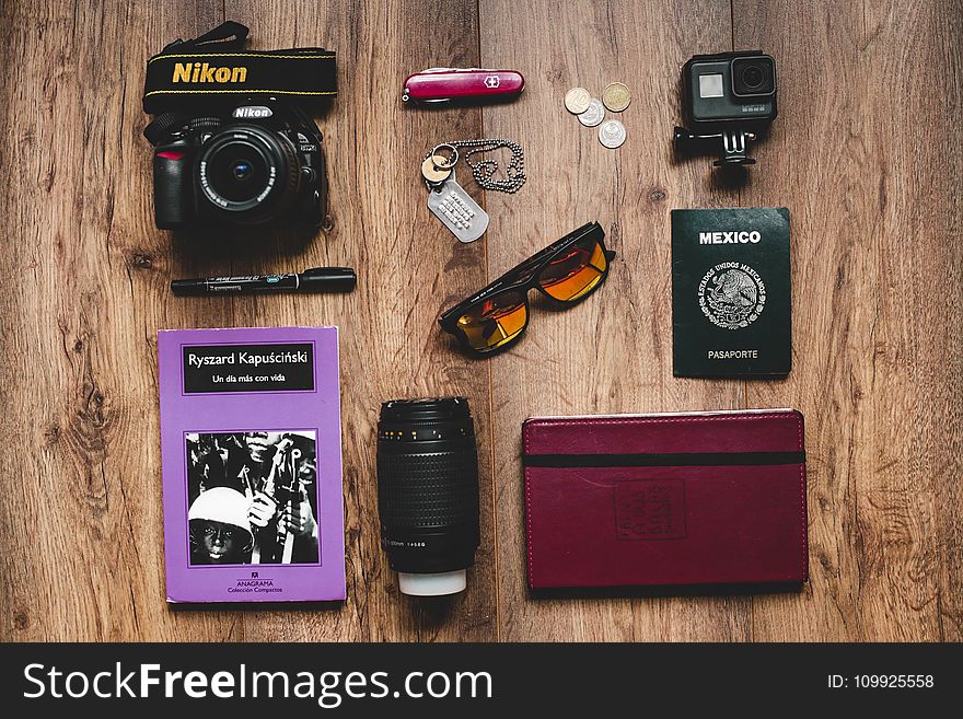 Black Nikon Dslr Camera, Gopro Hero Session, and Black Framed Sunglasses