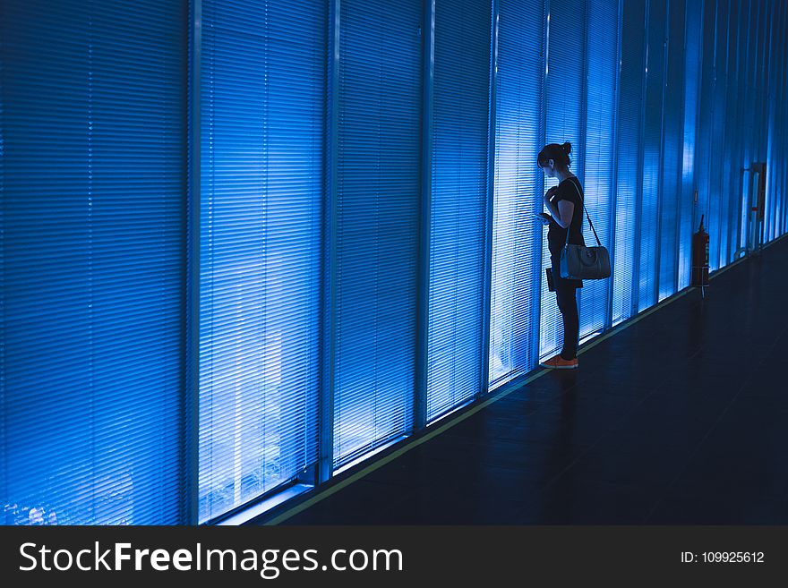 Woman Standing Near Blue Led Wall