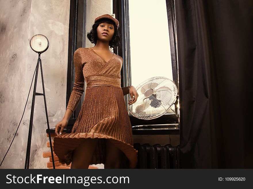 Woman in Long-sleeved Midi Dress Standing Near on Wall-mounted Fan