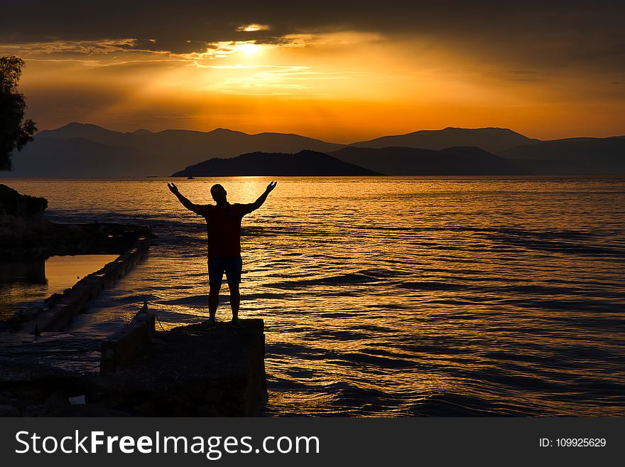 Silhouette Photo Of Person Standing Near Beach