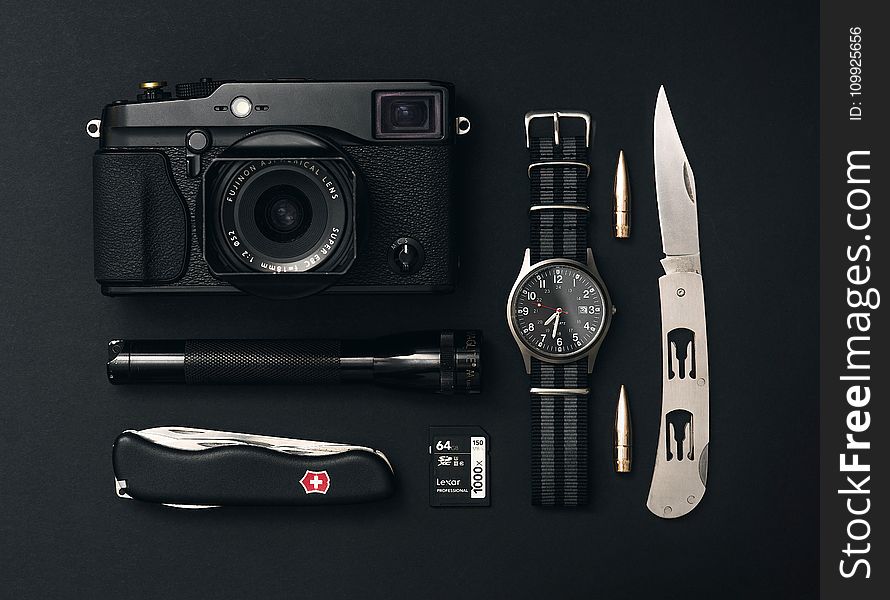 Black Point-and-shoot Camera, Analog Watch, and Flashlight