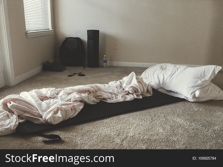 Two White Rectangular Pillows With White Blanket On Floor