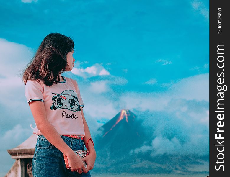 Photography Of A Girl In Front Of Erupting Volcano