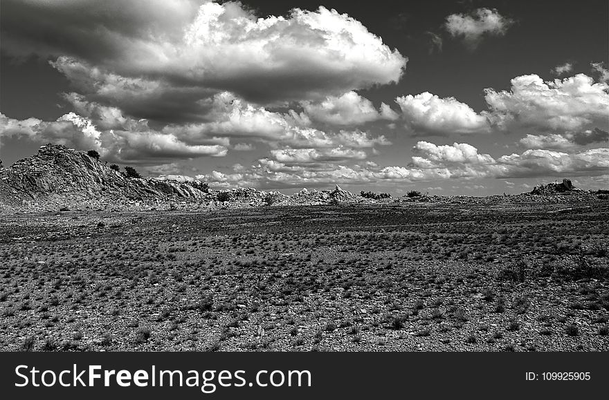 Grey Scale Photography of Open Field and Mountain