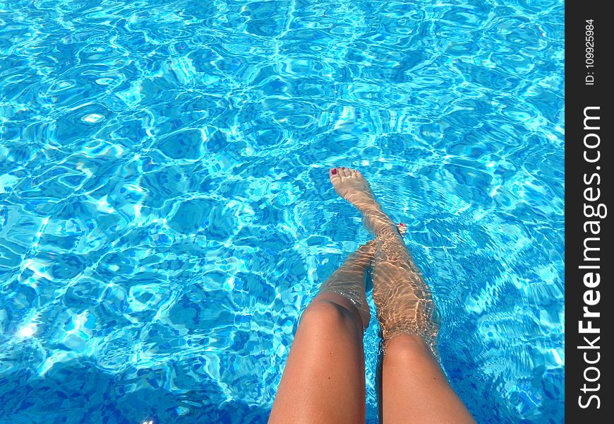 Person Feet Dipping on Pool